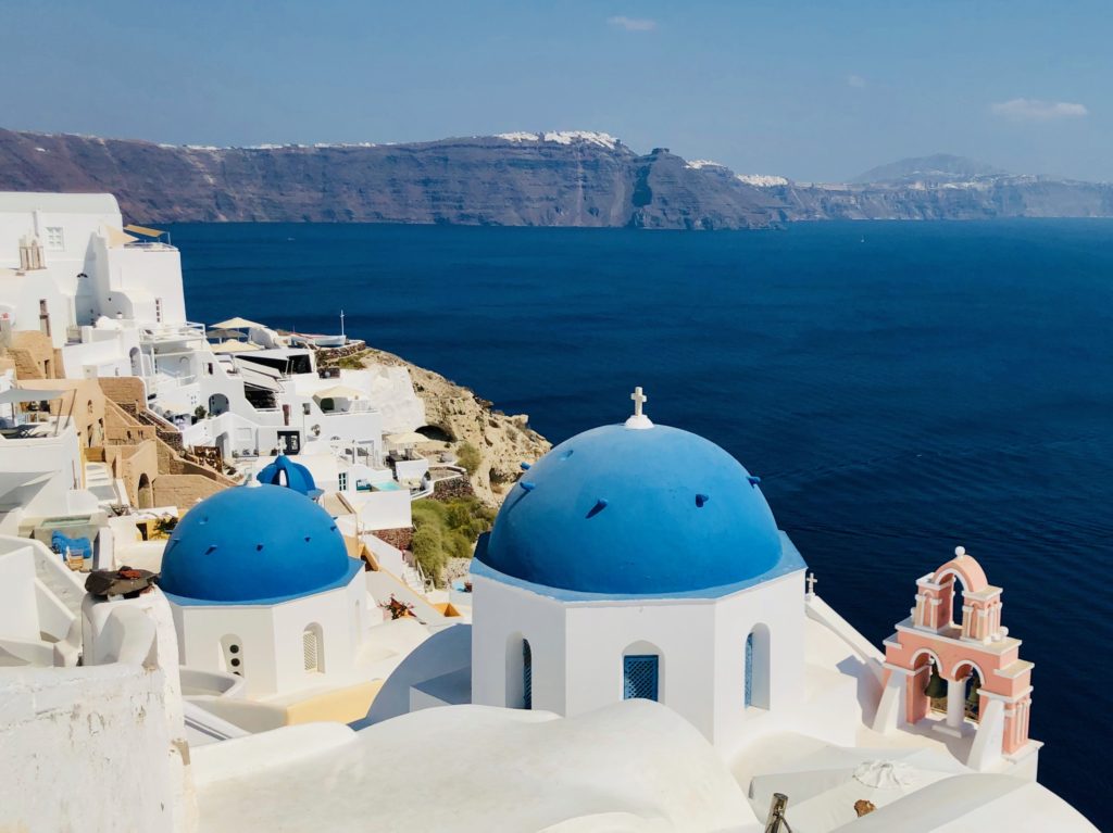 Photo of blue domed white building in the Mediterranean | Featured image for Cheese and the Mediterranean Diet.