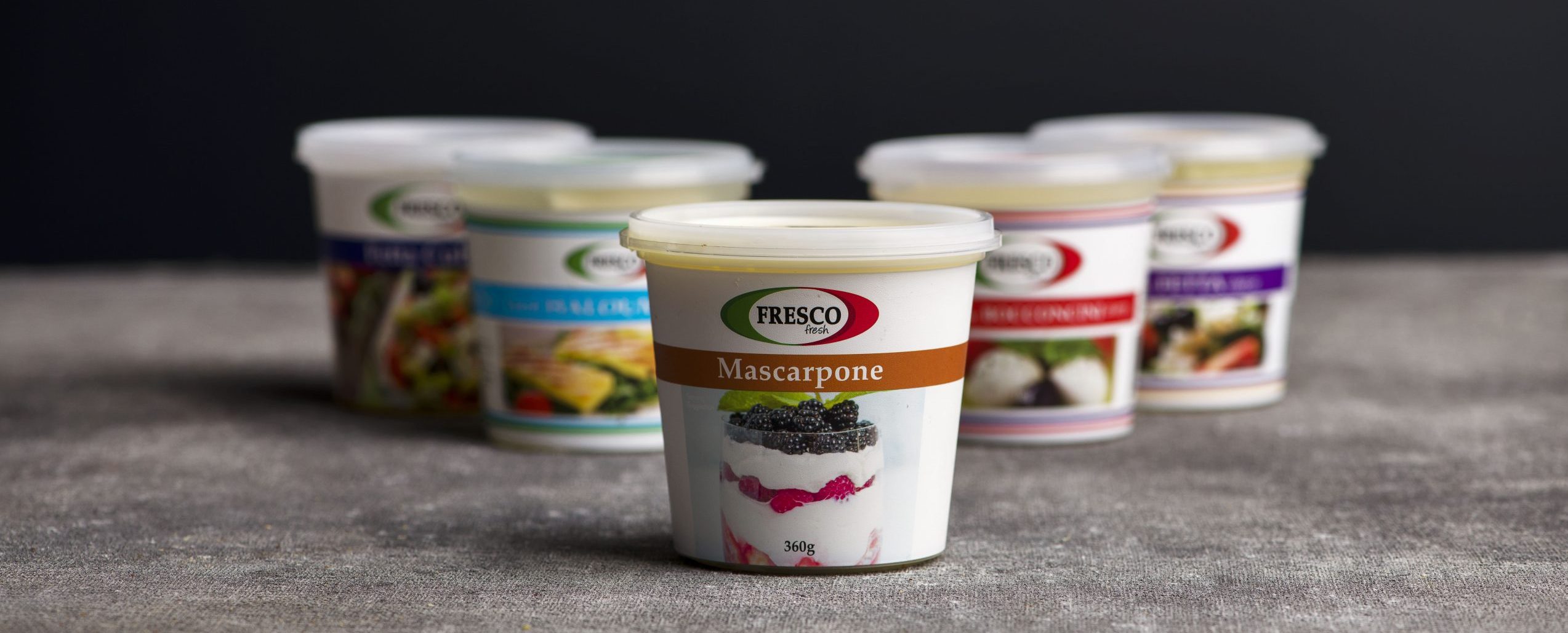 Photo of five cheeses arranged in a 'V' with Mascarpone in the front | Featured image for Fresco Cheese Wholesale.