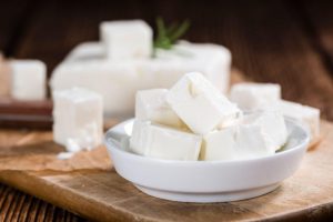 Fresh Fetta in a bowl featuring a block of Fetta in the background | featured image for Home.