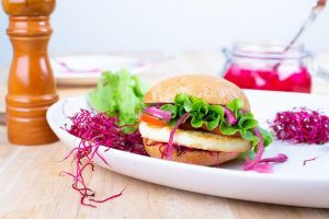 Wholesale Halloumi cheese from Fresco Cheese in a sandwich on a plate | featured image for Home.