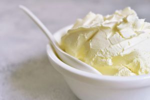 Photo of Mascarpone in a bowl with a spoon dipped into it | Featured image for Mascarpone.