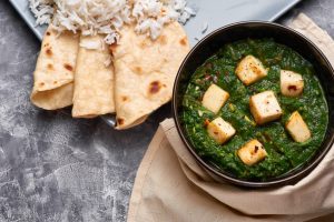 Photo of Paneer in a spinach curry next to grilled tortillas | featured image for Home.