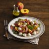 A salad with peaches, basil and cheese. | Featured image for Fresco Cheese.