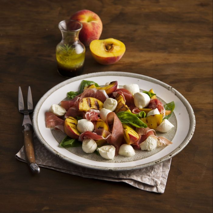 A salad with peaches, basil and cheese. | Featured image for Fresco Cheese.