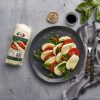 Mozzarella cheese with tomatoes, basil and sea salt on a plate. | Featured image for Fresco Cheese.