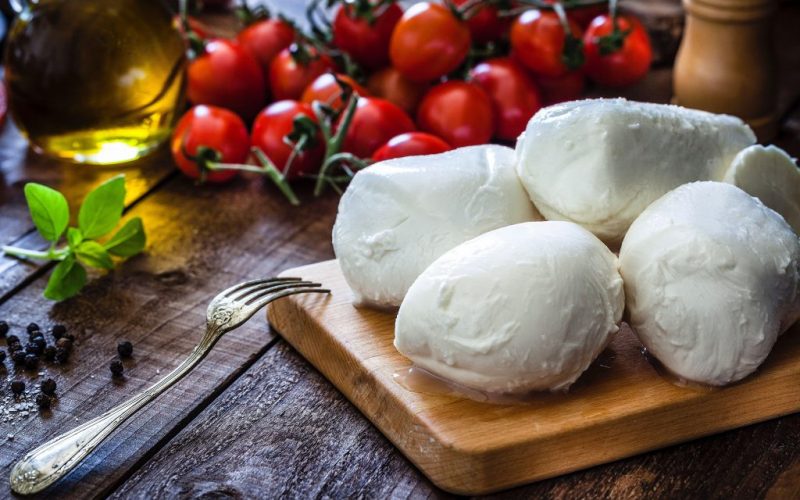 Photo of fresh Mozzarella on a cutting board | Featured image for What is Mozzarella Cheese blog for Fresco Cheese.